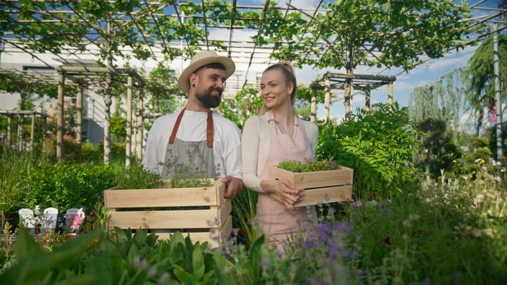 Joyful Gardeners Embrace the Greenhouse's Abundance