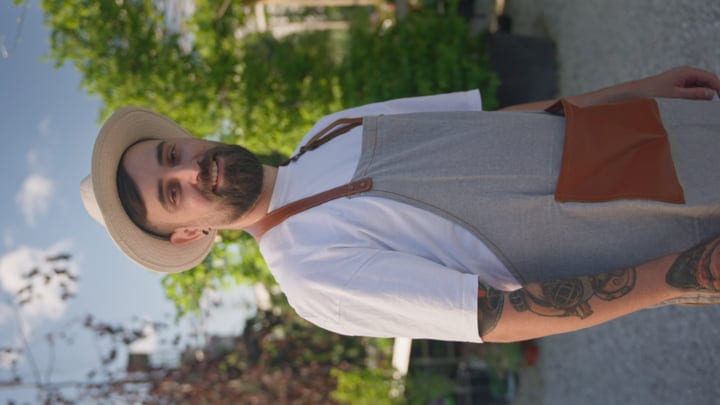 Sunlit Gardener Embraces His Craft In The Greenhouse