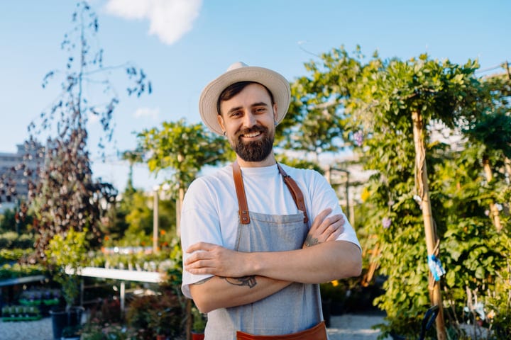 Smiling Gardener Enjoys a Sunny Greenhouse Day