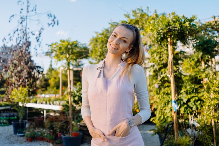 Young Gardener Joyfully Embraces the Greenhouse Life