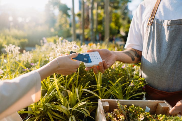 A Gardener Accepts Payment Amidst Greenery Bliss