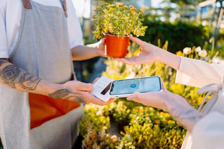 Contactless Payment Between Gardener And Customer In Greenhouse