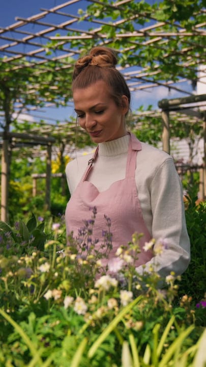 Serenity Blooms As Gardener Tends Her Greenhouse Oasis