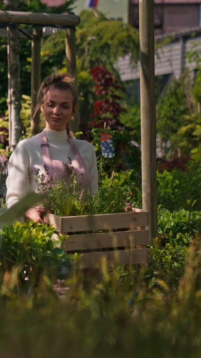 A Gardener Tends to Her Greenhouse Sanctuary