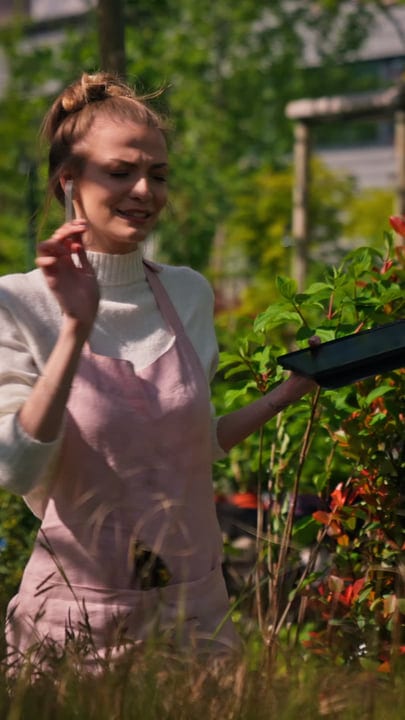 Joyful Gardener Embraces Nature's Bounty In Greenhouse Scene