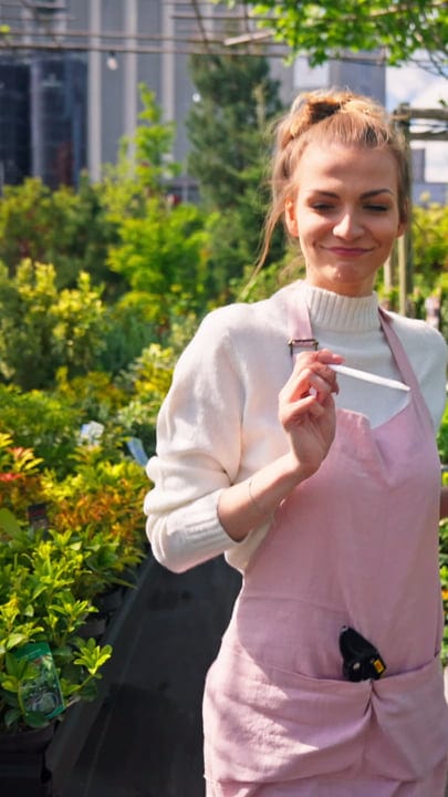 Joyful Gardener Embraces Greenhouse Serenity in Spring