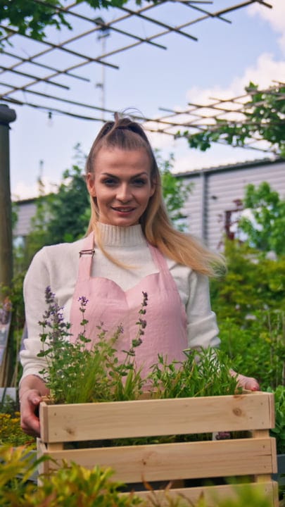 Joyful Gardener Tending Her Greenhouse Oasis