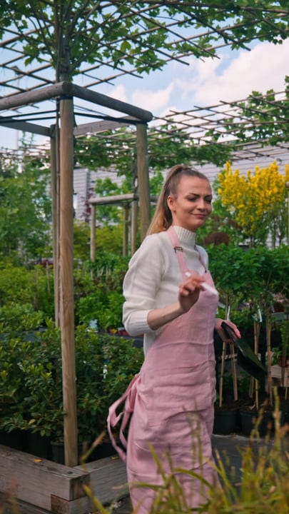Joyful Gardener Embracing Nature's Growth in the Greenhouse