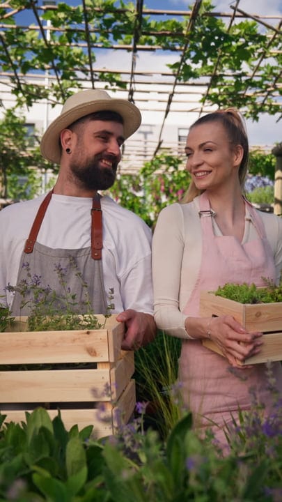 Two Gardeners Share a Moment in the Greenhouse