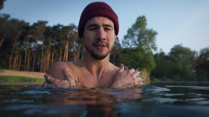 Brave Swimmer Embraces Cold Water in Tranquil Setting