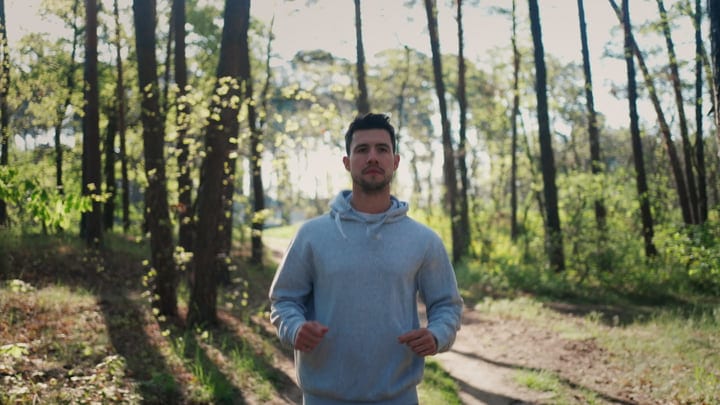 Man Embracing Nature During Early Morning Jog