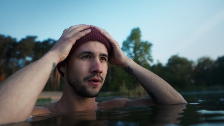 Man Embraces the Chill of Early Morning Swim