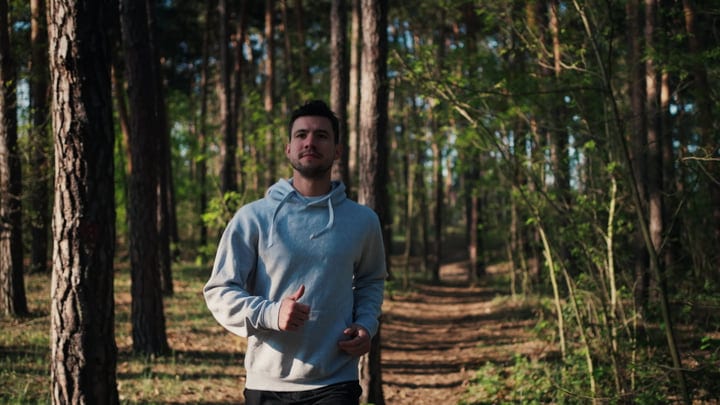 Man Embraces Early Morning Run Through Forest