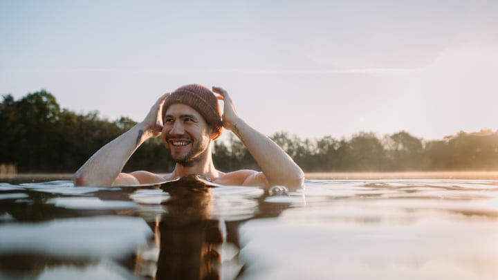 A Man Embraces the Chill of Early Morning Swim