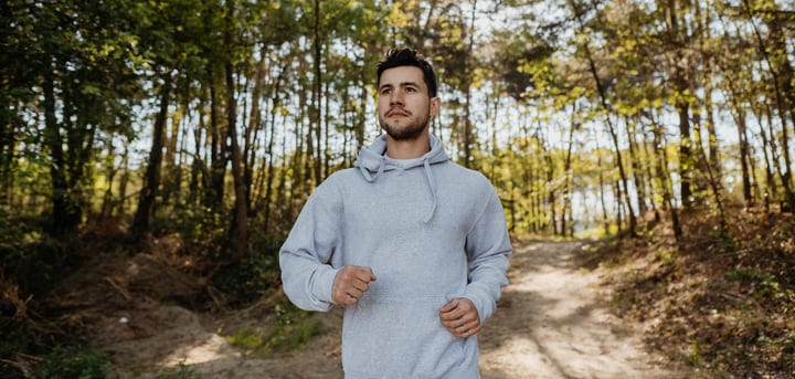 Man Embraces Nature During an Autumn Forest Walk