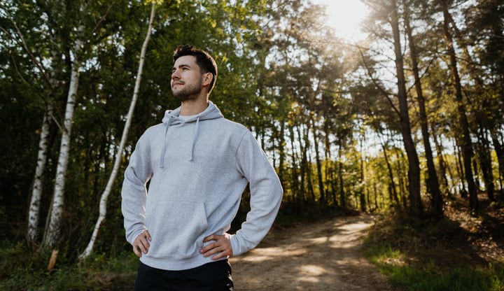 Man Embraces Tranquil Morning In Forest Glade