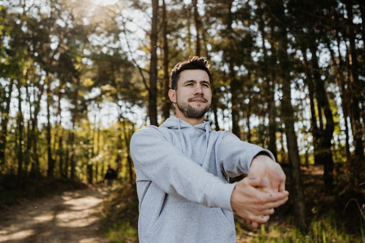 Man Embraces the Chill in Forest Serenity