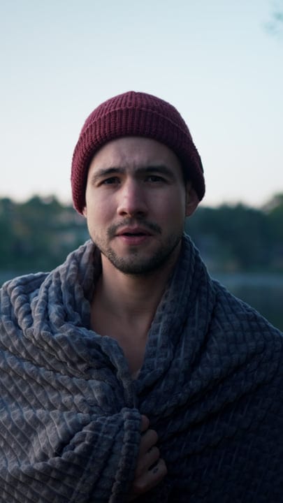 Embracing The Chill: Man Wrapped In Cozy Blanket