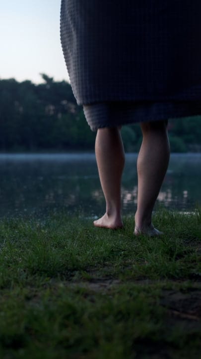 Barefoot Man Prepares For A Cold Lake Swim