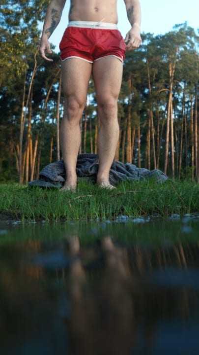 Embrace The Chill: Man Standing By The Lake Edge