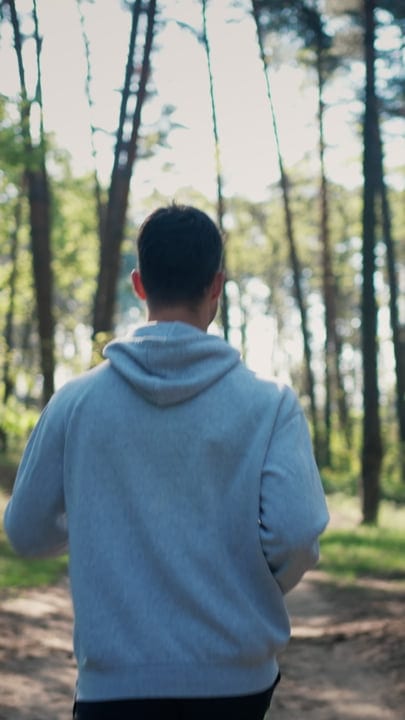 Man Embraces Nature In A Tranquil Forest Walk