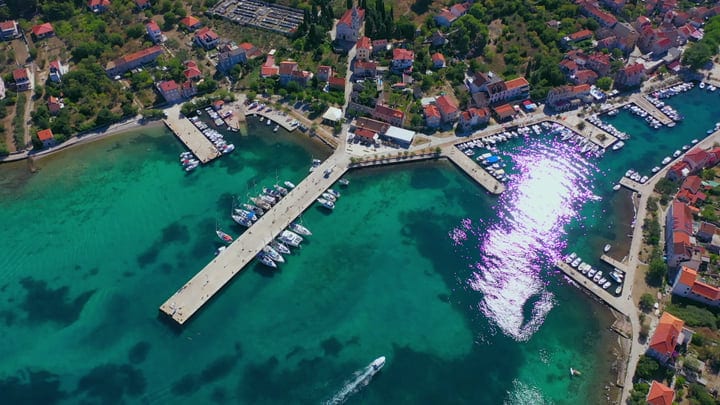 Sailboats Rest Gracefully In A Turquoise Mediterranean Bay