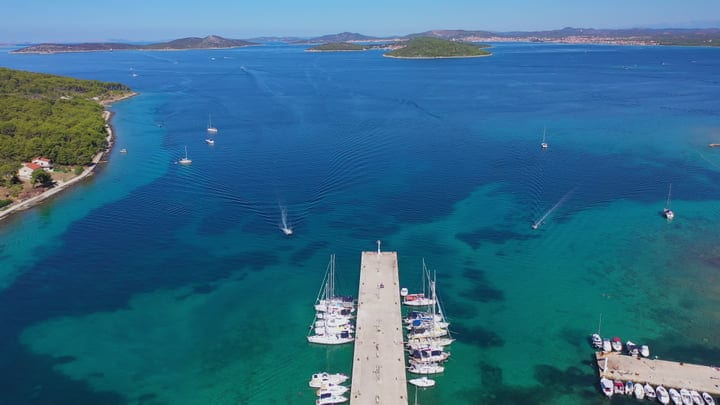 Sailboats Gather At Pier In Turquoise Bay Panorama