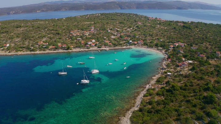 Sailboats Anchored in a Serene Turquoise Bay