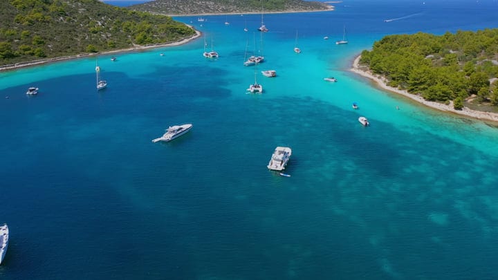 Sailboats Grace The Tranquil Waters Of Turquoise Bay