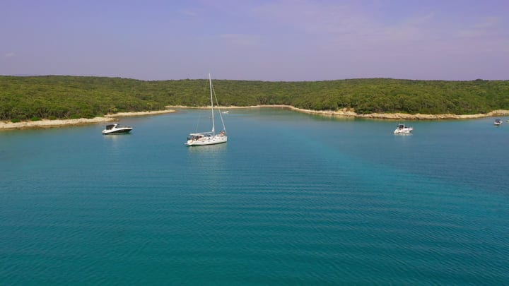 Serene Sailboats Drift in Tranquil Turquoise Waters
