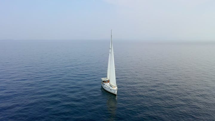 Serenity Sails on a Calm Turquoise Bay Morning