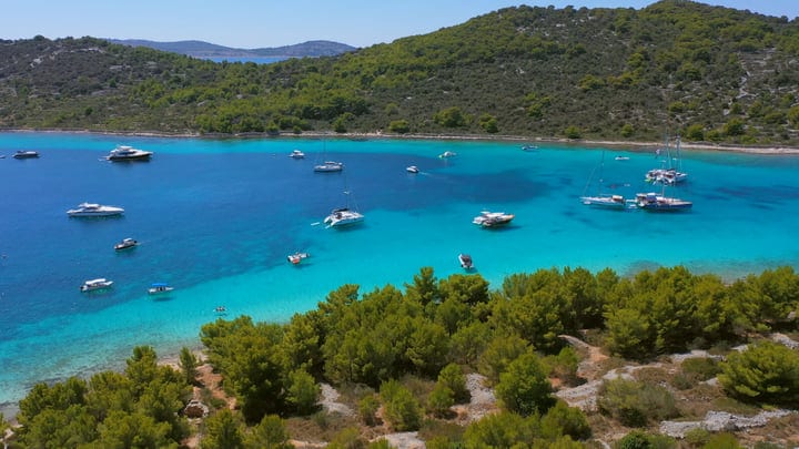 Sailboats Drift Calmly In Turquoise Mediterranean Bay Waters
