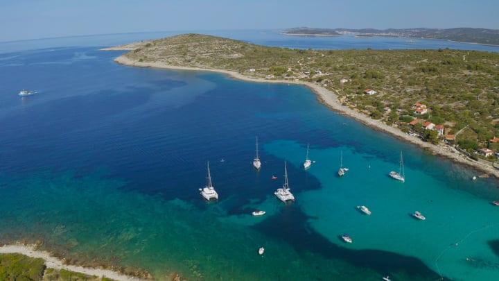Sailboats Gracefully Drift In Turquoise European Bay