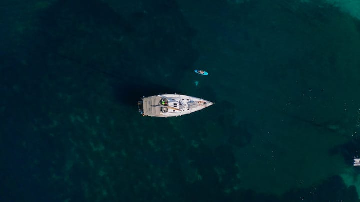 Sailboat Glides Through Turquoise Waters On A Summer Day