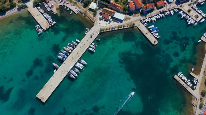 Aerial View Of Sailboats Docked In Turquoise Bay Marina