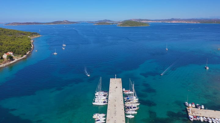 Sailboats Moored at a Tranquil Turquoise Bay Pier