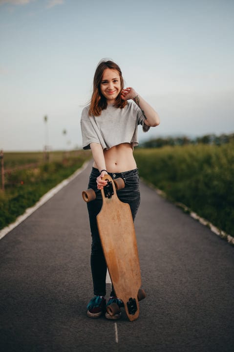 Confident Young Skateboarder Enjoys a Sunny Country Road