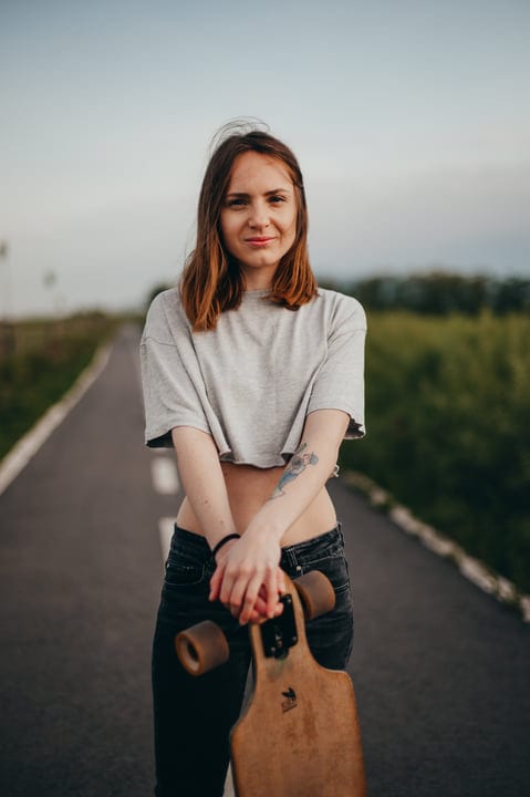 Confident Skateboarder Embraces The Freedom Of The Open Road