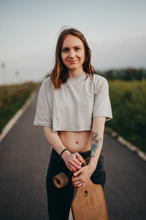 Confident Young Skateboarder Embraces The Open Country Road