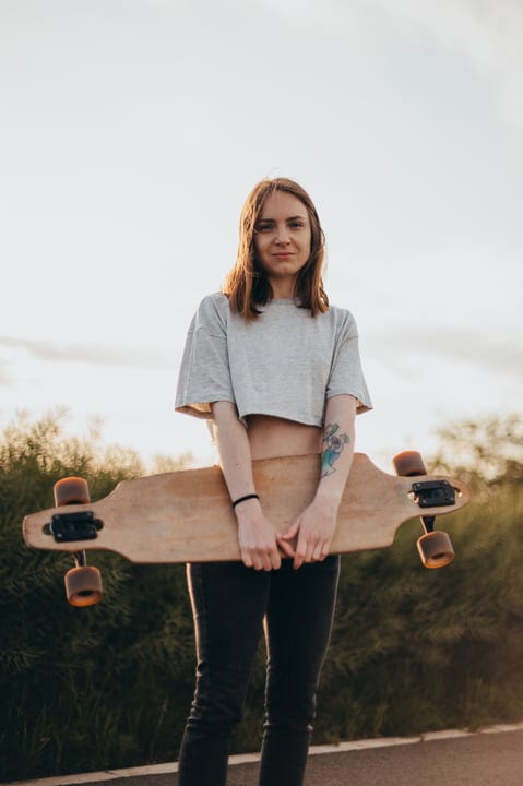 Sunlit Moments With A Skateboard On A Country Road