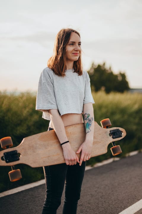 Sunset Smiles With A Skateboard On Country Road