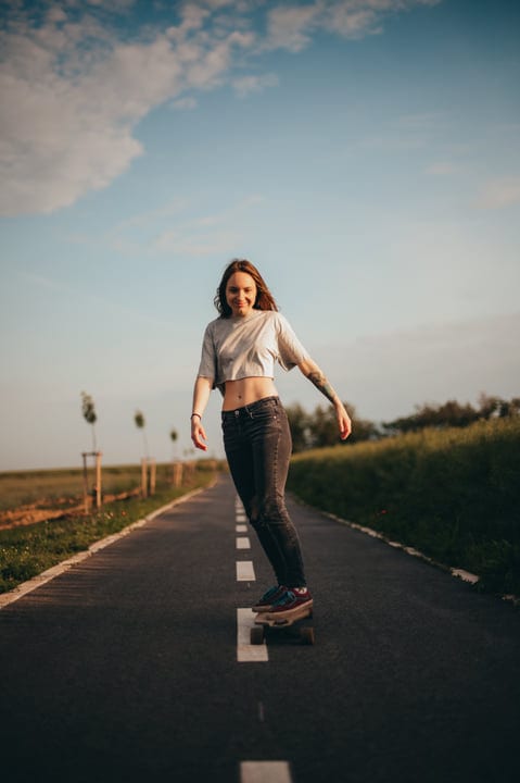 Skateboarding Joy Under A Vast Blue Sky