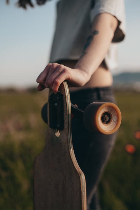 An Adventurer's Grip On A Sunlit Country Road