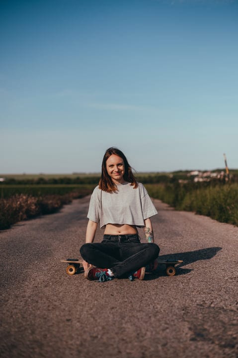 Skater Takes A Moment On A Sunlit Country Road