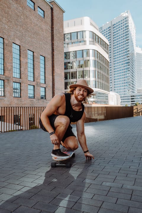 Skater Prepares For An Urban Adventure At Sunset