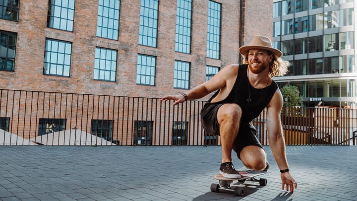 Joyful Skater Embraces the Urban Sunset Vibes