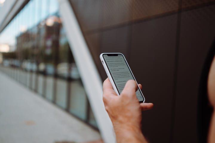Checking Messages Against A Modern Urban Backdrop