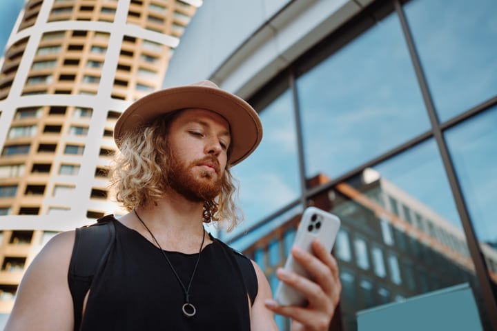 Modern Skater Checks His Phone At Sunset