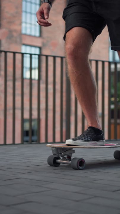 Skater Glides Effortlessly Through Urban Sundown Streets