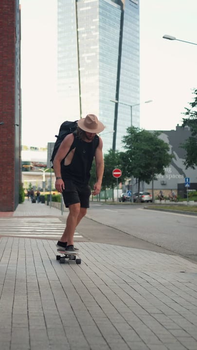 Skater Glides Through Downtown at Sunset in Summer